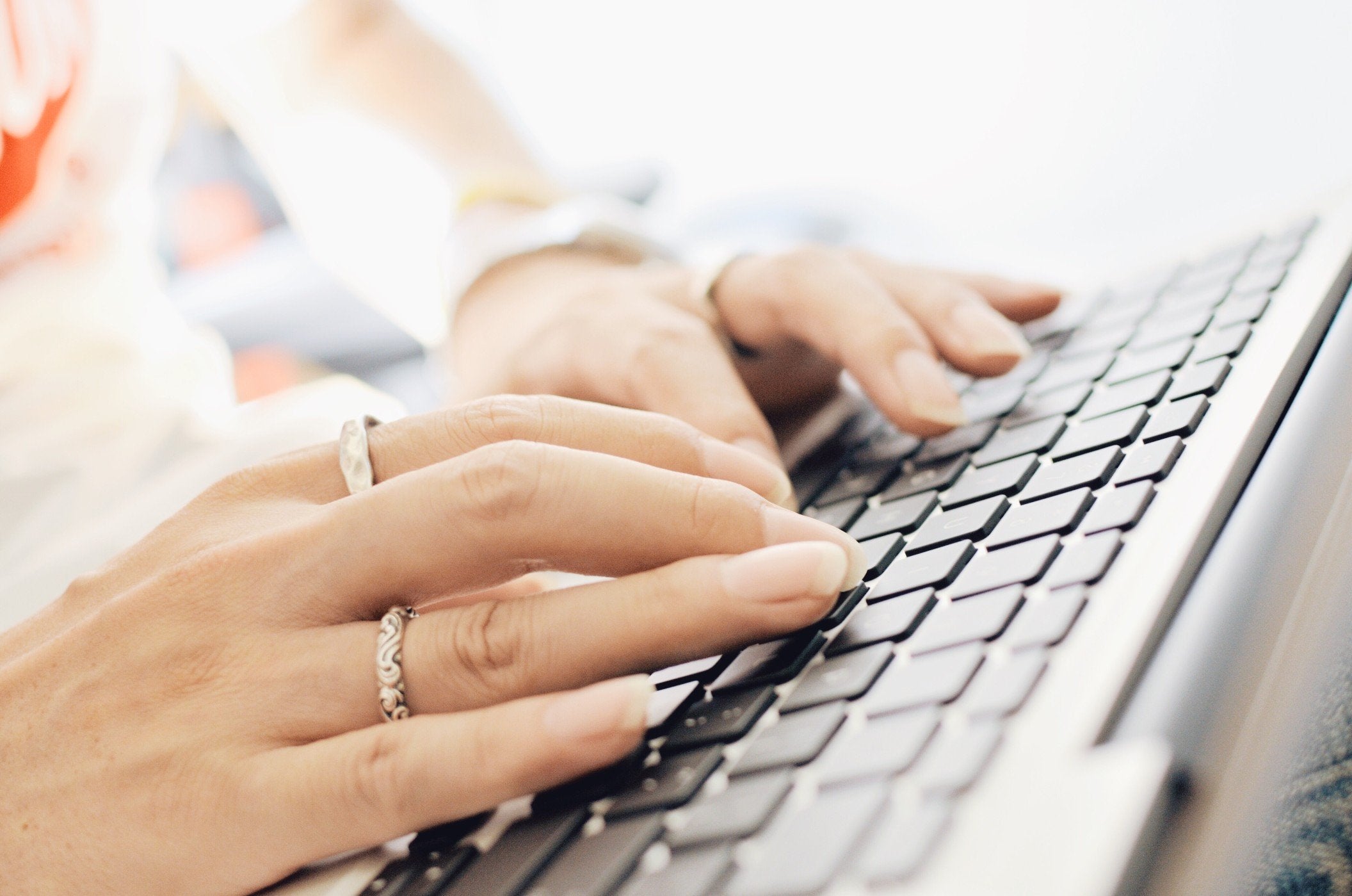 Woman typing on a keyboard