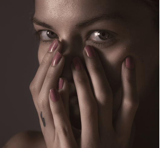 Woman looking at the camera hiding hyperpigmentation on her face