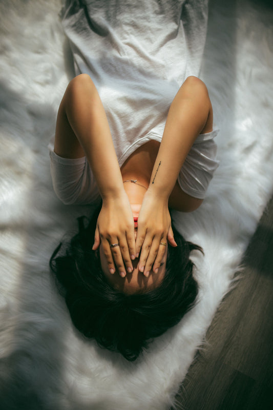 Woman With Her Hands Over Her Face Hiding Hyperpigmentation Melasma