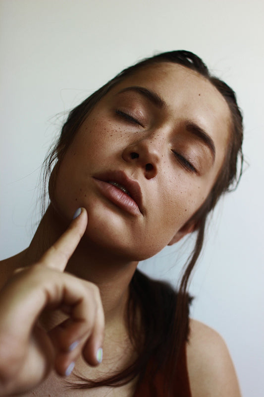 Woman with eyes closed thinking about Melasma and Treatment for Melasma