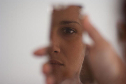 Woman reflection in a small handheld mirror
