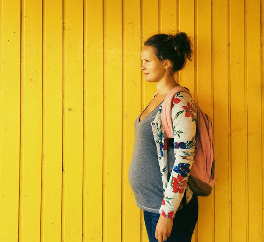Is Hydroquinone Safe During Pregnancy Pregnant woman standing with a back pack
